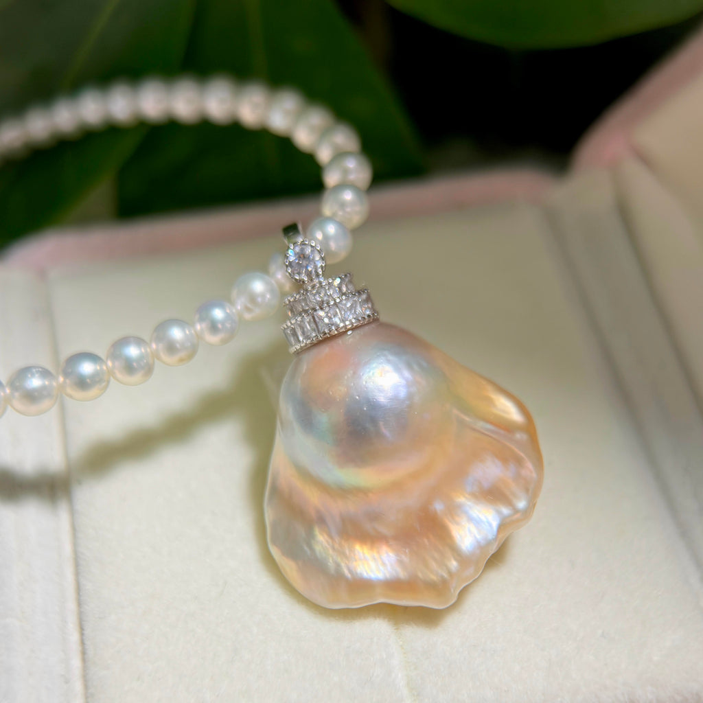 Freshwater pearl jewelry featuring golden-blue baroque pearl pendant with light golden halo and universal sterling silver bail.