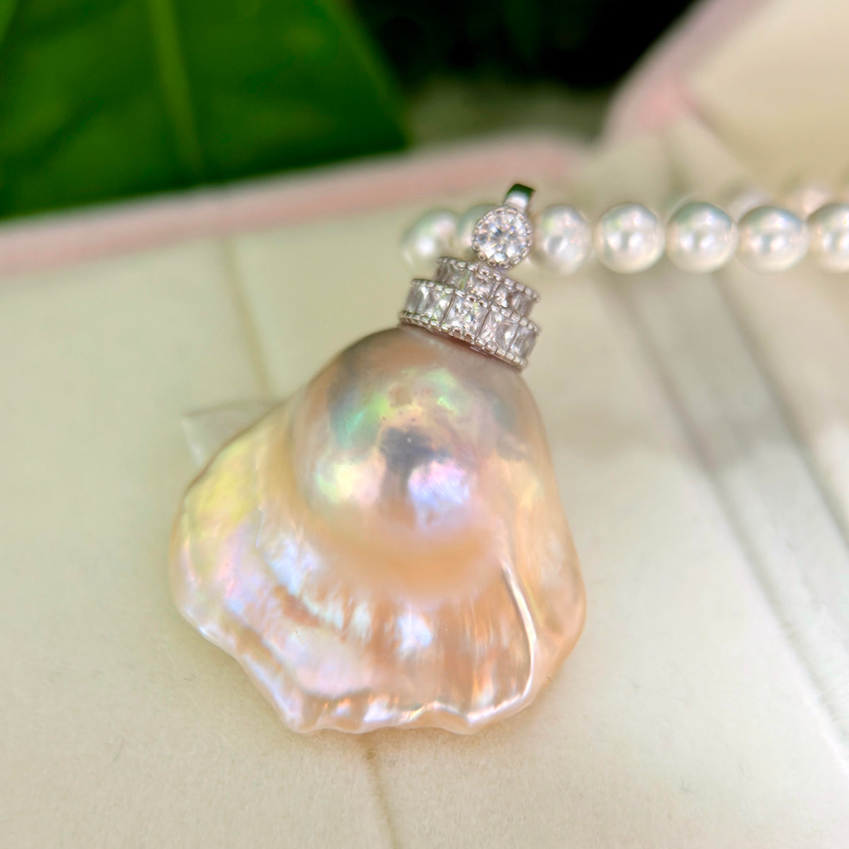 Iridescent halo detail on golden-blue baroque freshwater pearl pendant with light golden halo and universal sterling silver bail.