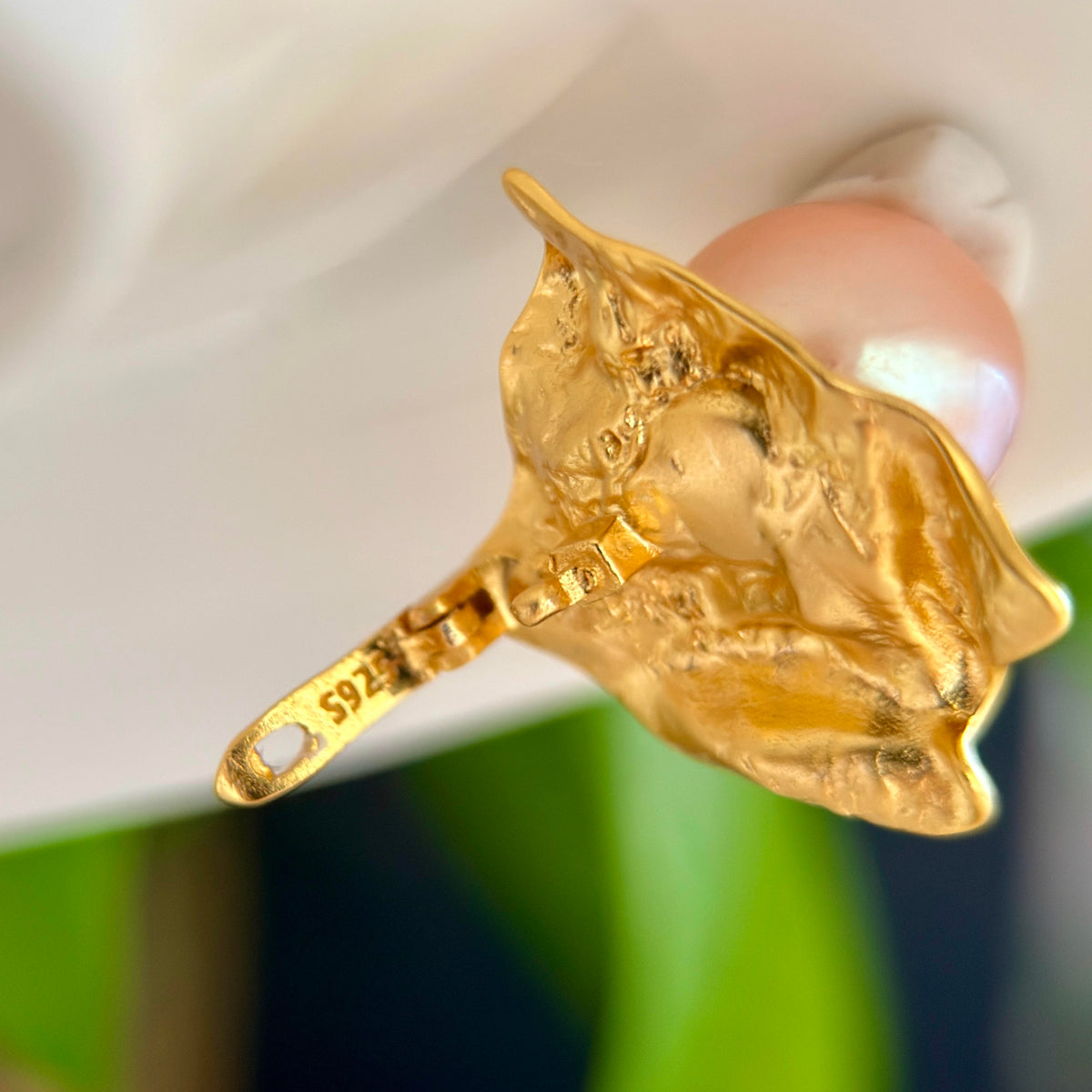 Close-up of a natural 11.8 mm golden freshwater pearl pendant.
