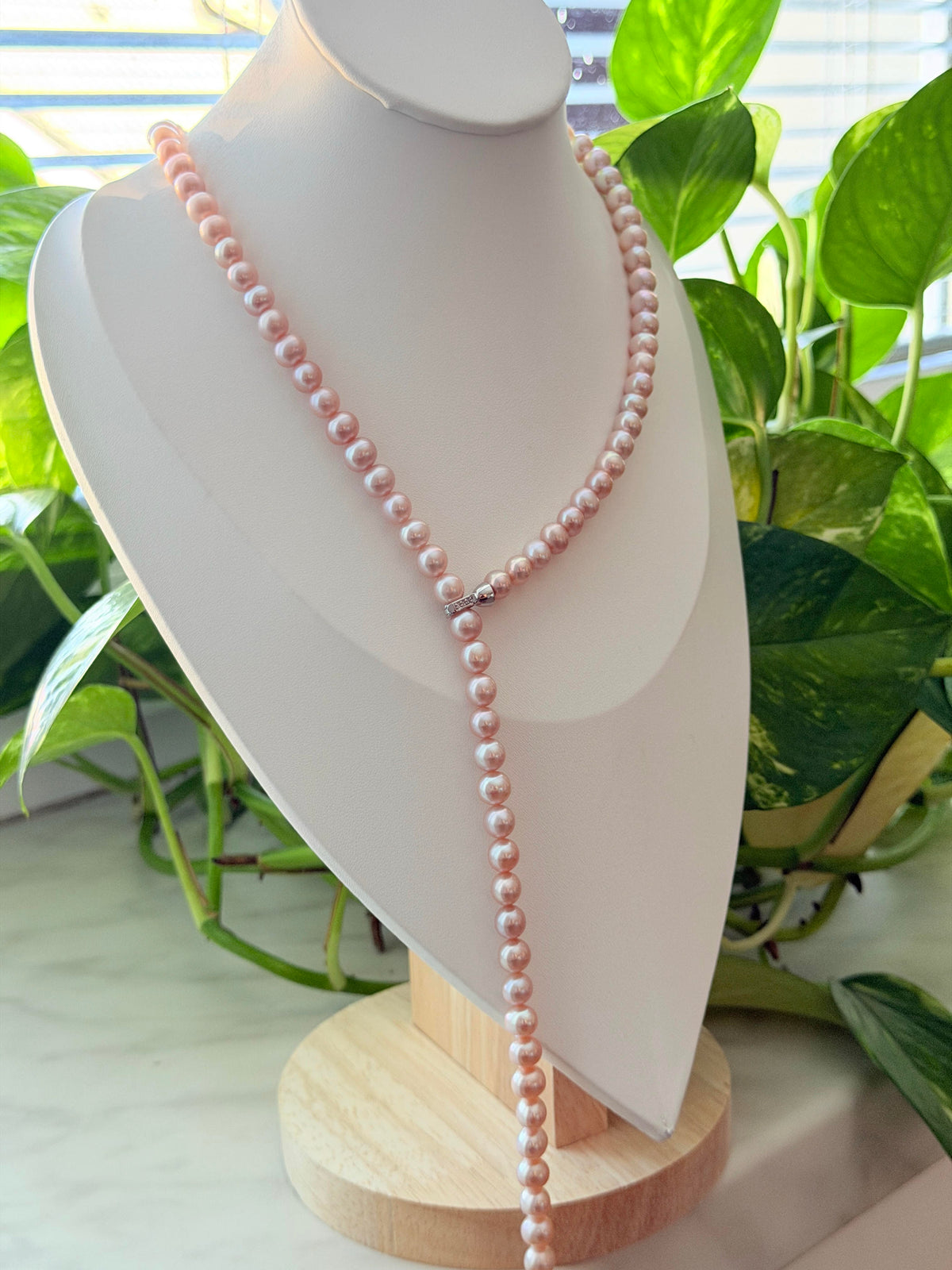 Convertible long pearl necklace styled in a graceful Y-shaped design.