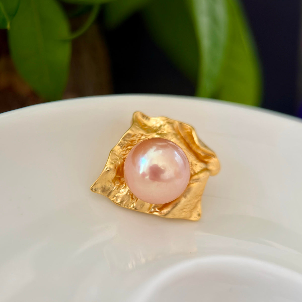 Golden pearl pendant styled as statement jewelry for special occasions.