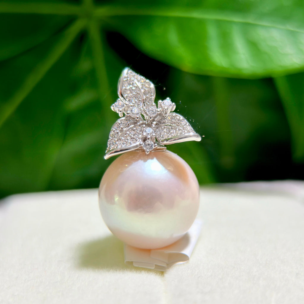 Oversized 15 mm white freshwater pearl pendant with a soft pink halo.