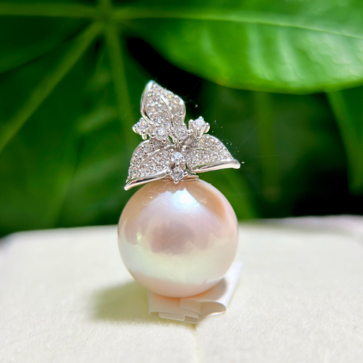 Oversized 15 mm white freshwater pearl pendant with a soft pink halo.