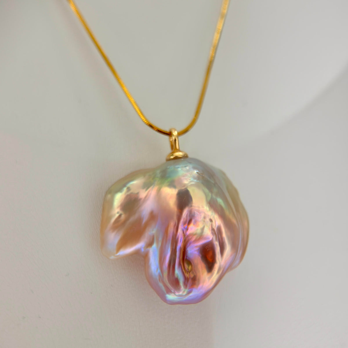 Lotus-inspired multicolor baroque freshwater pearl pendant on sterling silver snake chain.