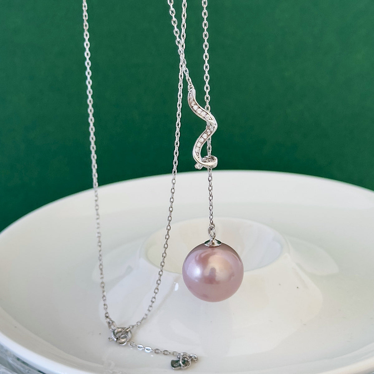 Large purple freshwater pearl necklace styled for elegant evening wear.