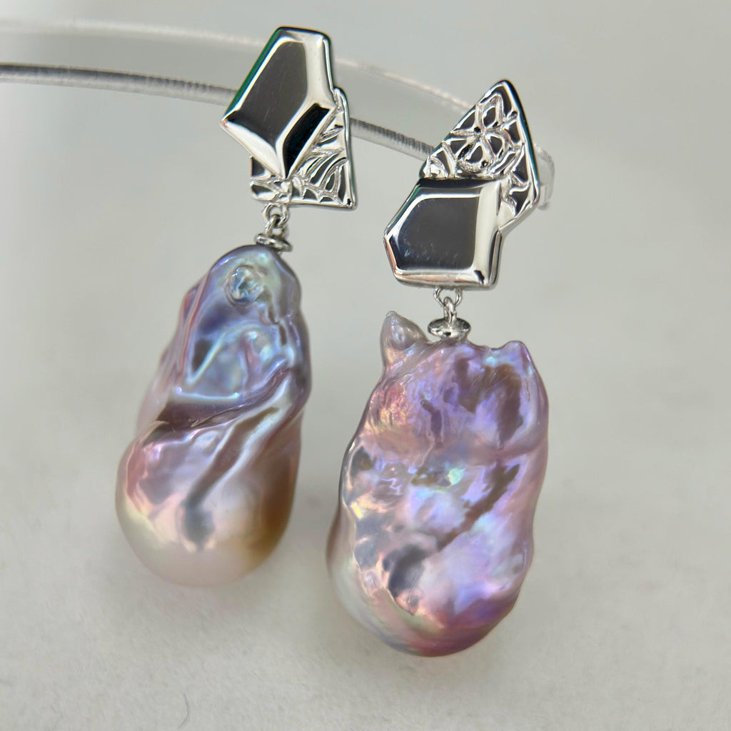 Organic pearl shape shown in purple-blue baroque freshwater pearl earrings with asymmetric geometric sterling silver frames.