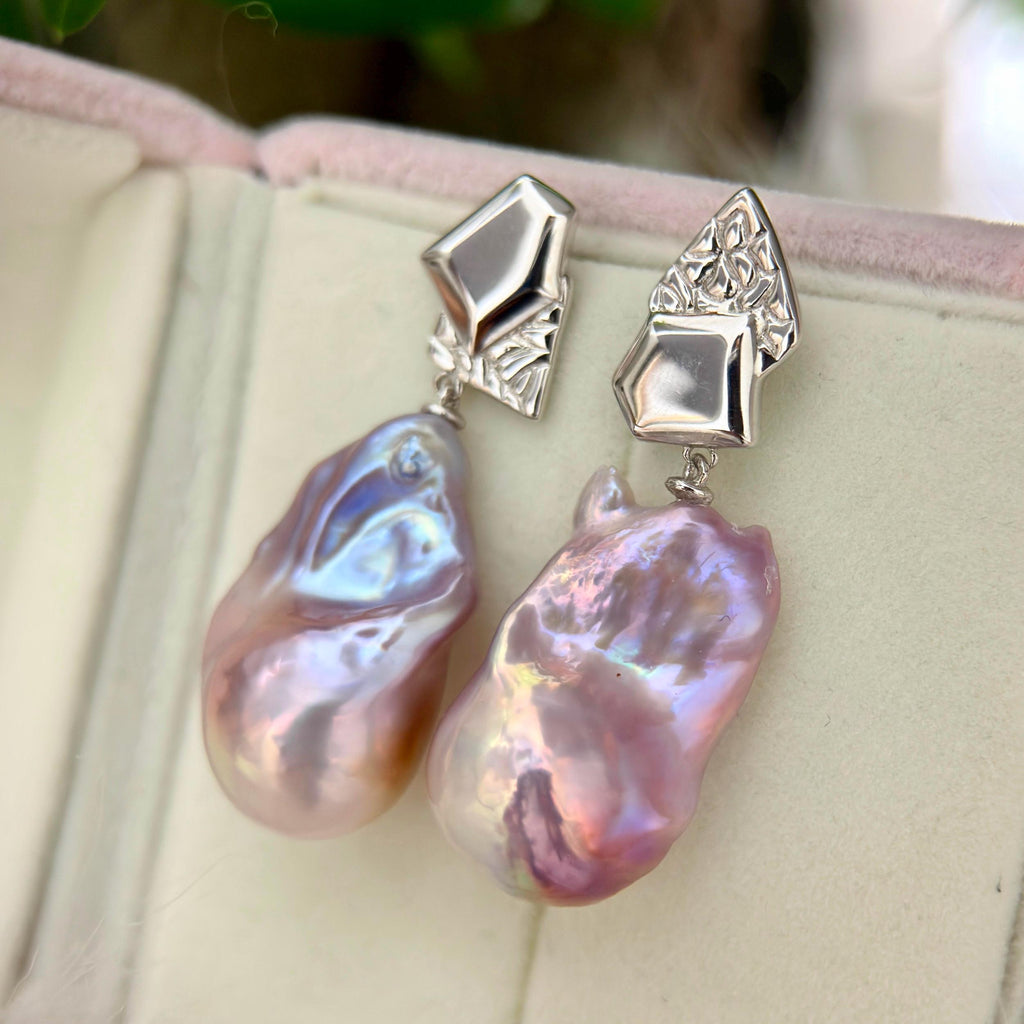 Freshwater pearl jewelry featuring purple-blue baroque pearl earrings with asymmetric geometric sterling silver frames.
