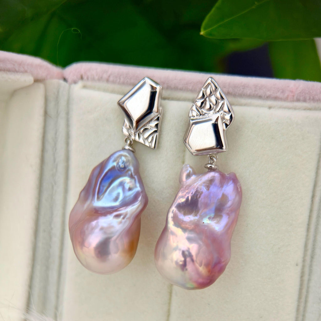 Purple-blue baroque freshwater pearl earrings with asymmetric geometric sterling silver frames.