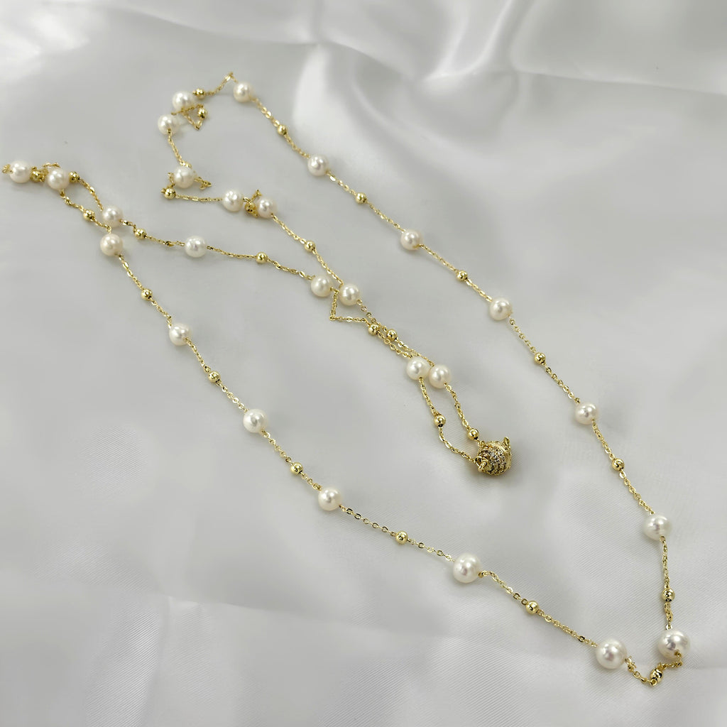 Natural white pearls paired with a delicate gold-tone chain.
