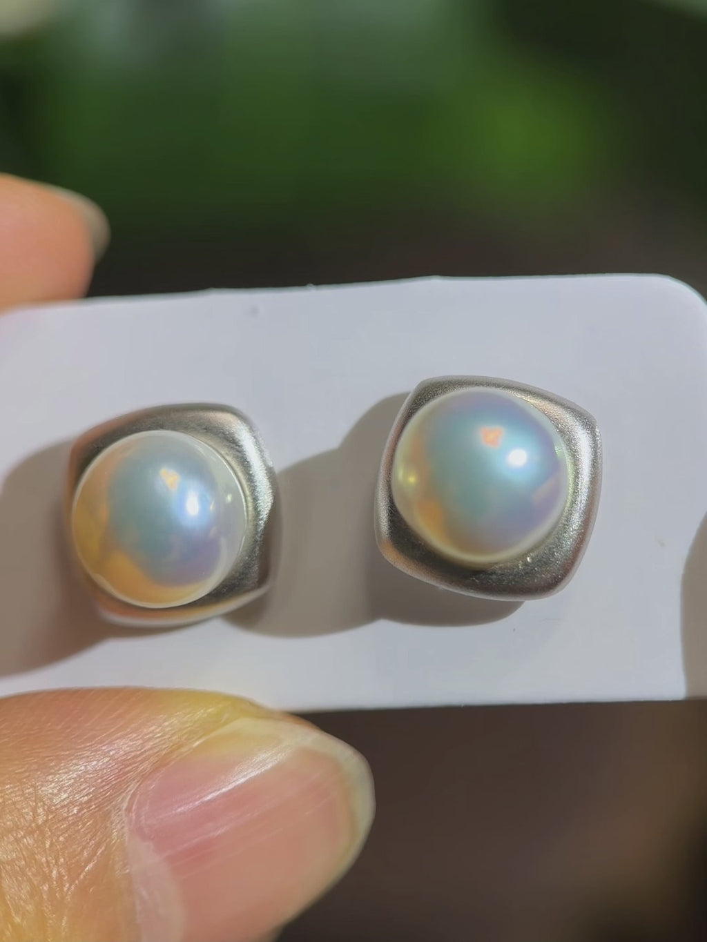 Modern pearl earrings presented as a refined gift for her.