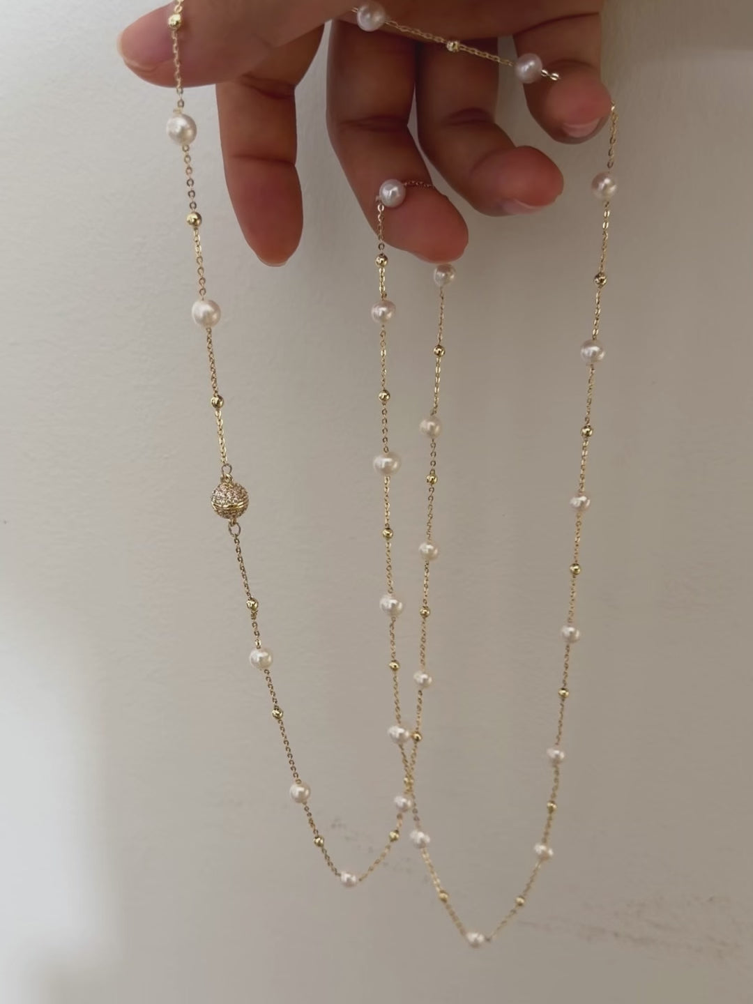 Layered freshwater pearl jewelry featuring luminous white pearls.