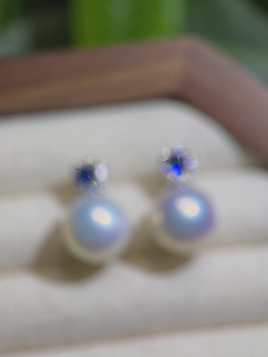 Close-up of cool blue halo white freshwater pearl earrings.
Unique freshwater pearl earrings styled for a special occasion.