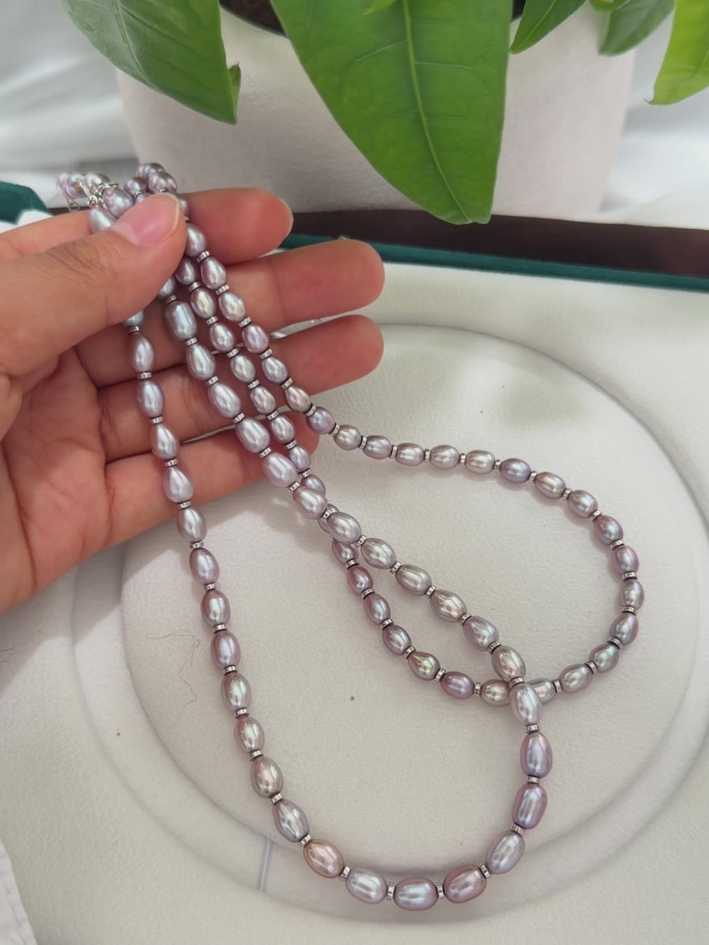 Close-up of purple oval pearls showing strong natural iridescence.