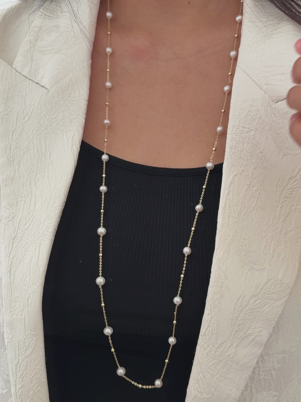Model wearing the long white freshwater pearl necklace.
Model wearing the pearl necklace doubled for a layered look.
