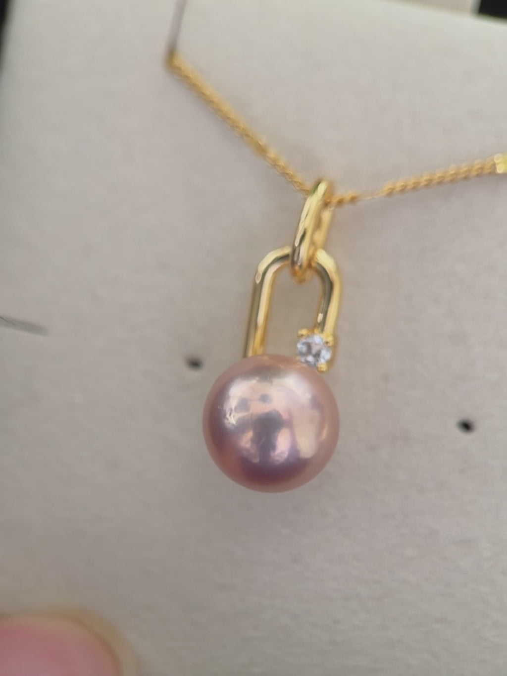 Near-round freshwater pearl pendant with modern minimalist styling.