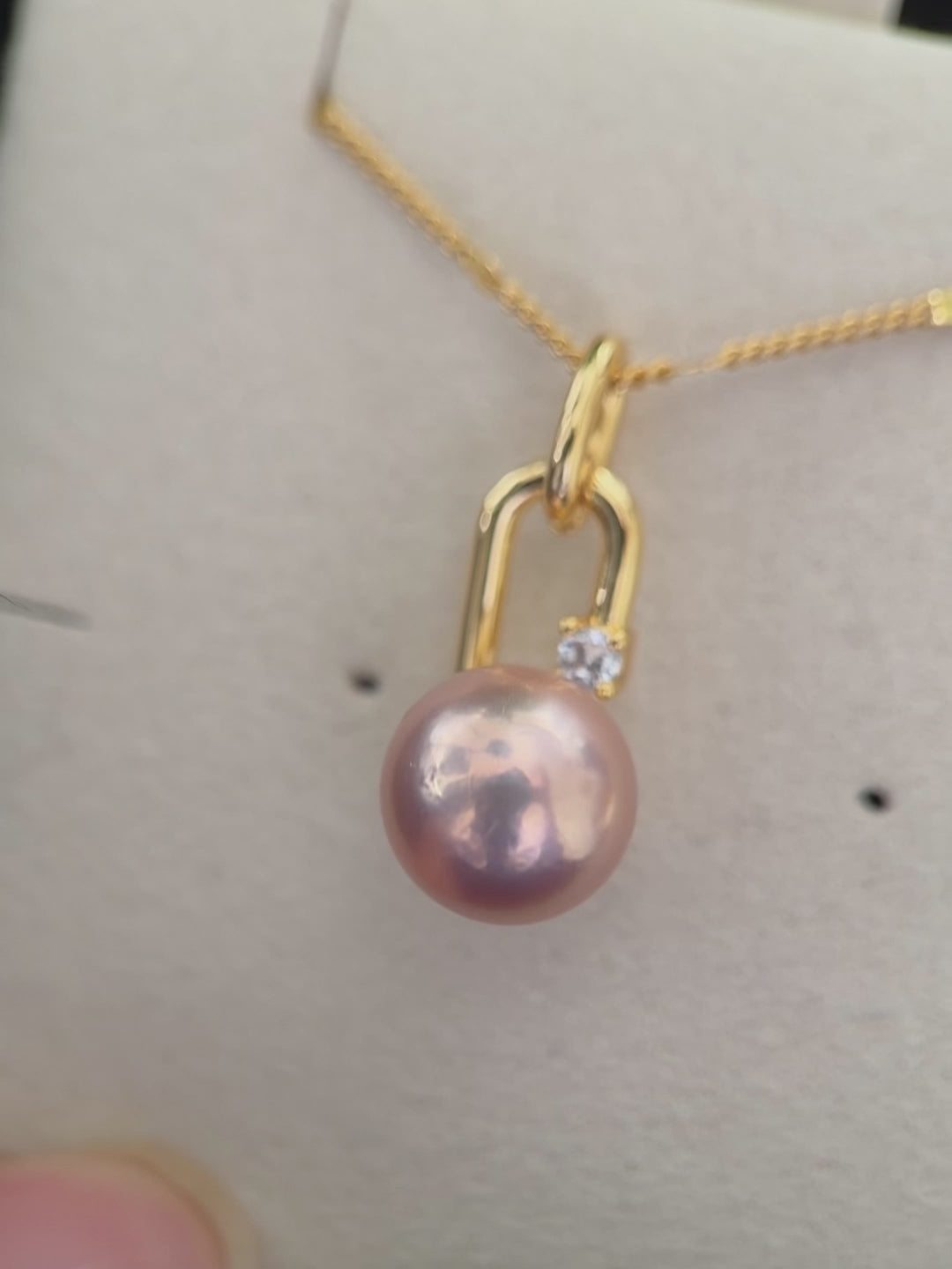 Near-round freshwater pearl pendant with modern minimalist styling.