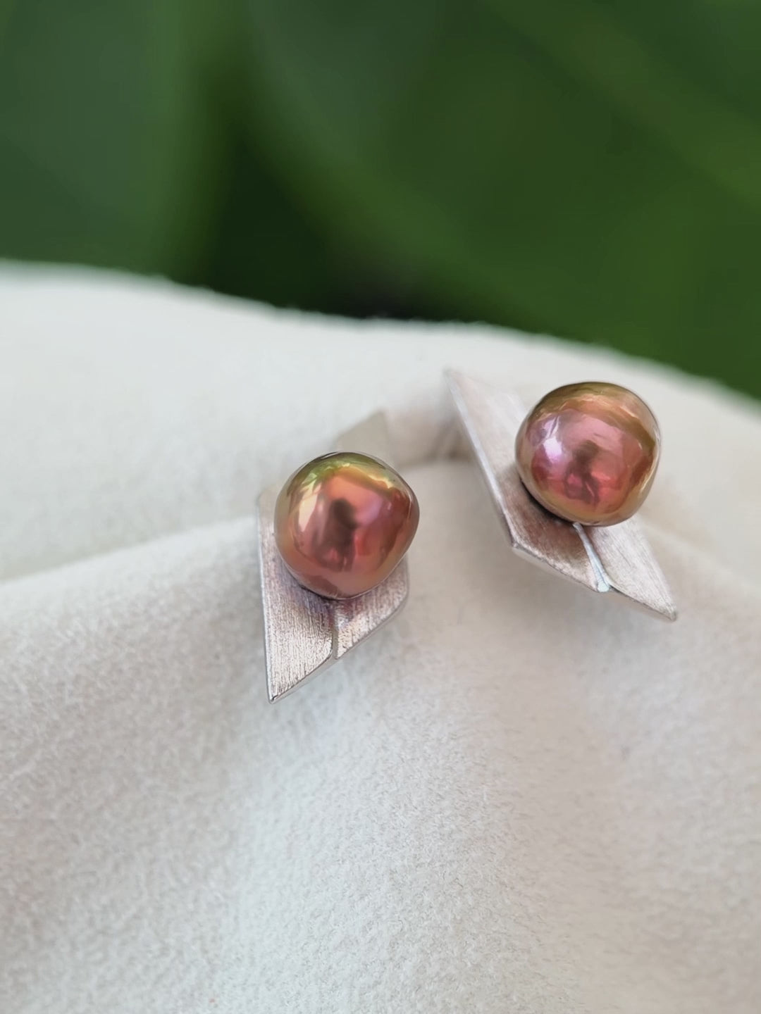 Geometric pearl stud earrings presented as a refined gift for her.