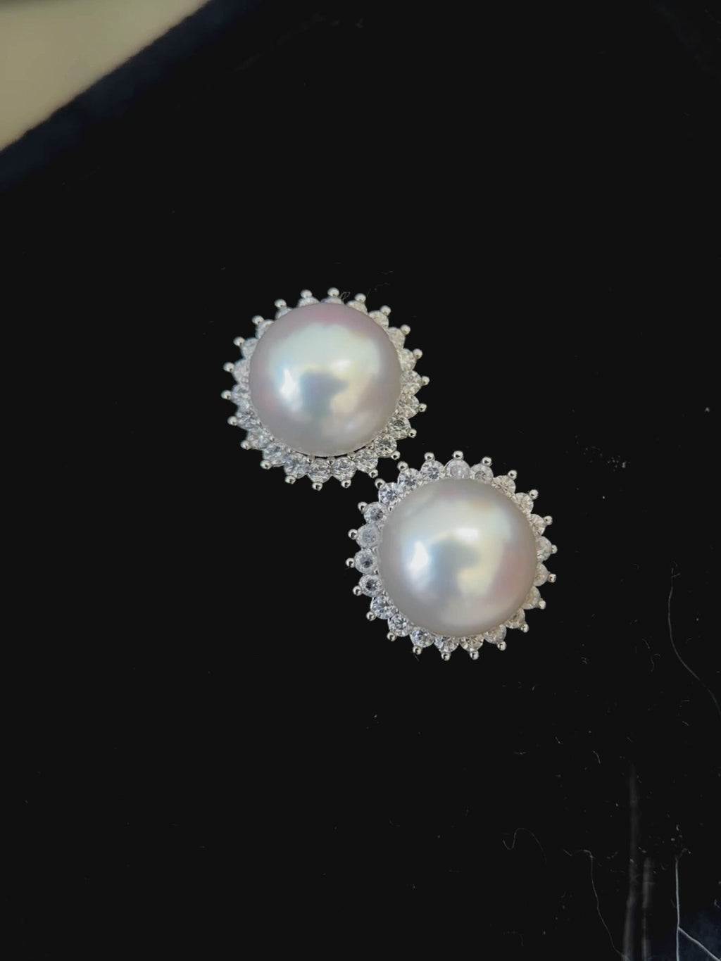 Elegant white pearl stud earrings suitable as a refined gift for her.