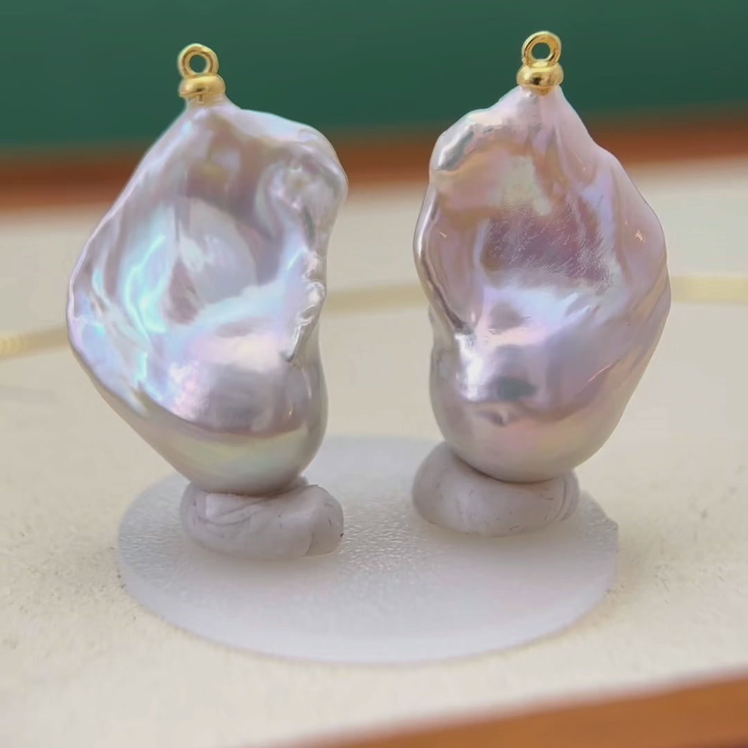 Convertible pearl earrings with detachable pearl drops that can be worn as pendants.