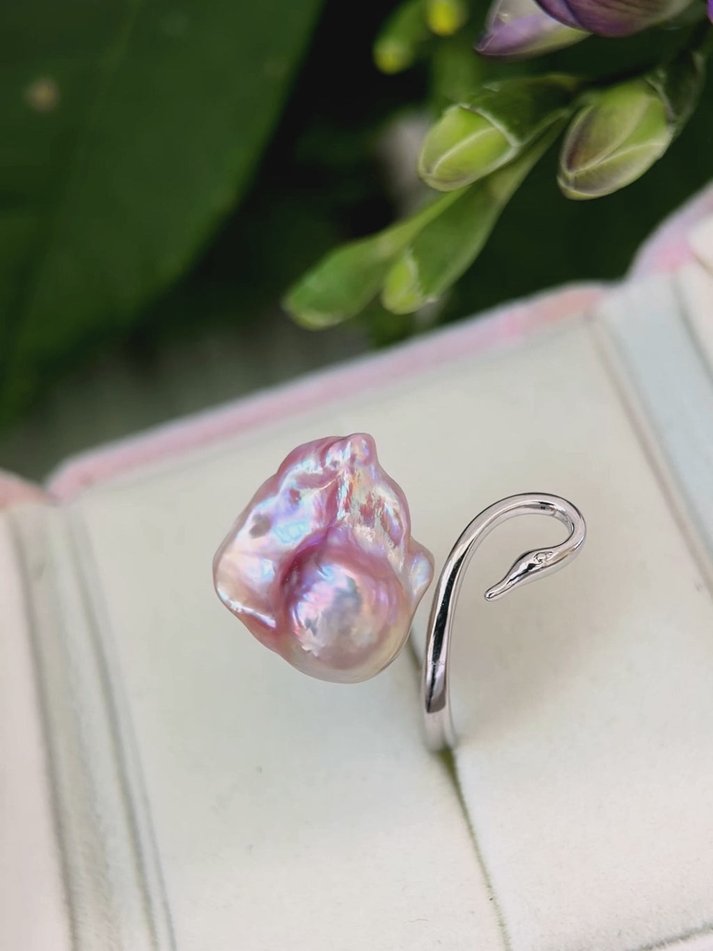 Pink-purple baroque freshwater pearl adjustable swan ring with silver-plated copper setting.