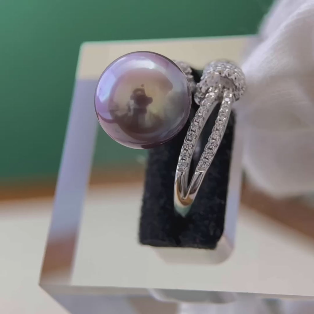 Sterling silver pearl ring with a romantic bow-inspired design.