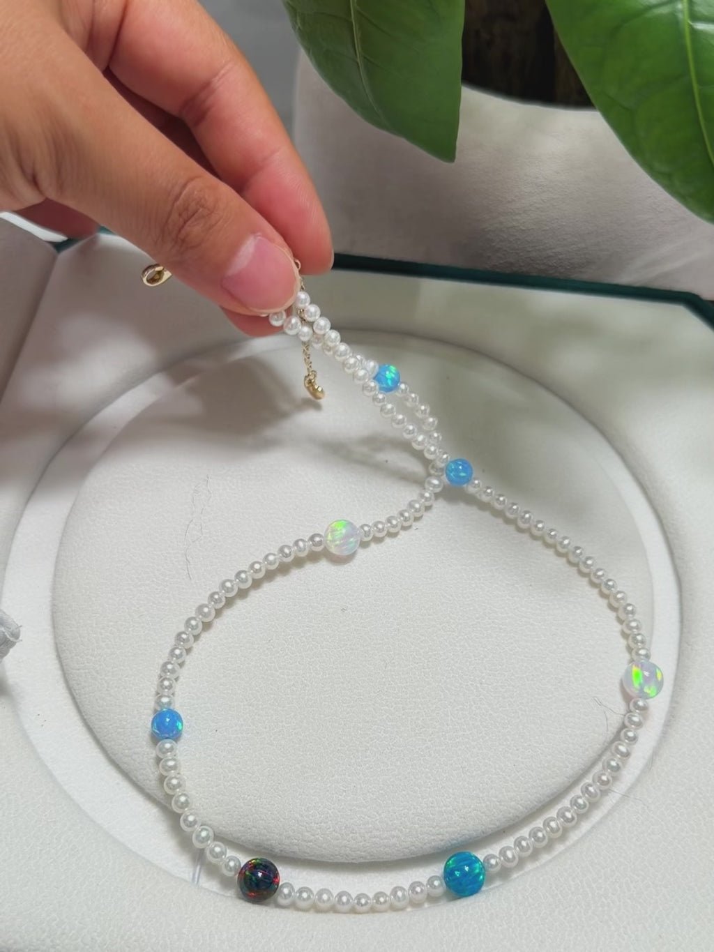Colourful opal and pearl necklace styled as a distinctive jewelry gift.
Cosmic-inspired necklace combining bright pearls with opal planet-like accents.
