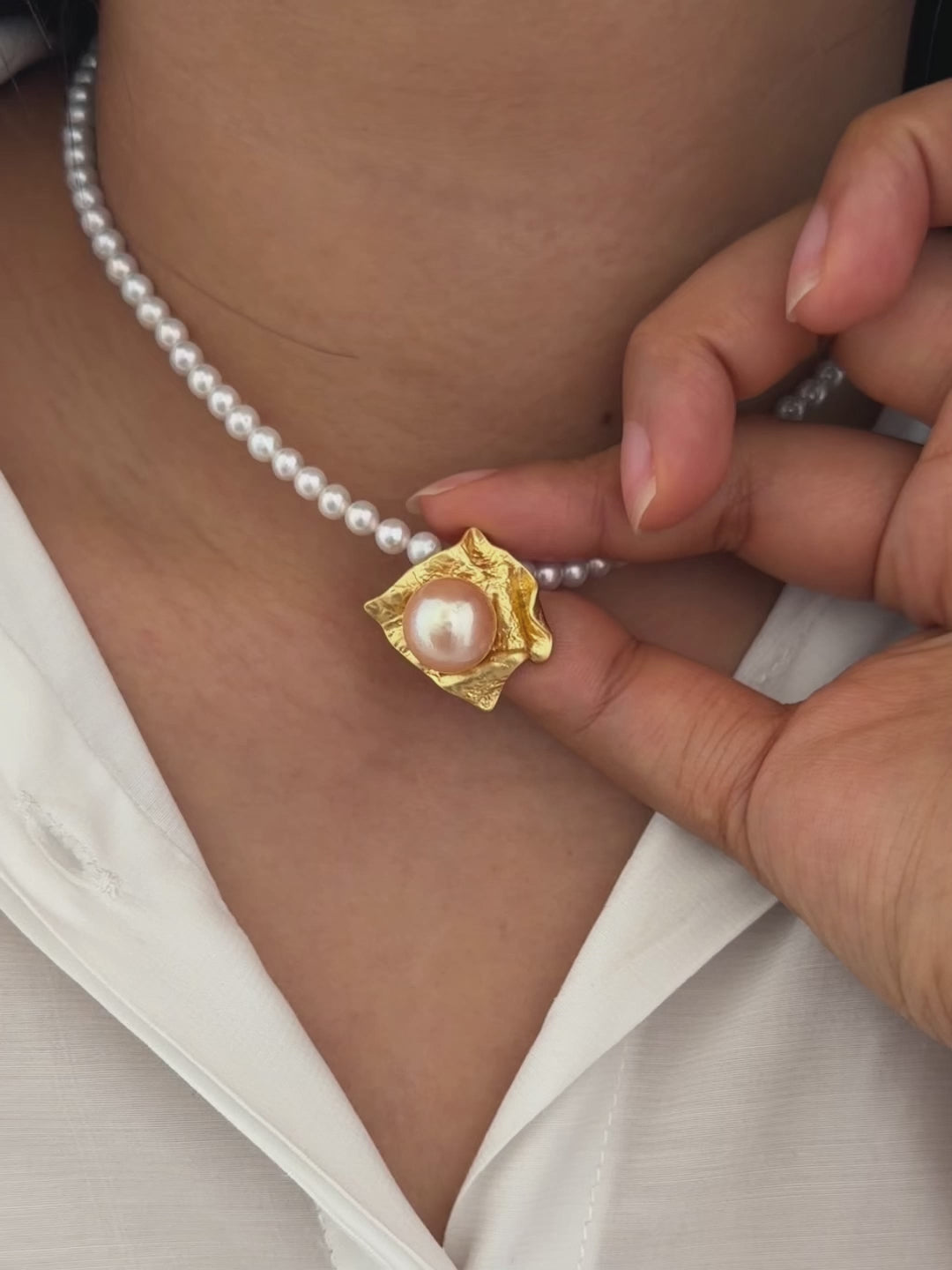 
Modern wearable-art pearl pendant with sculptural organic folds.