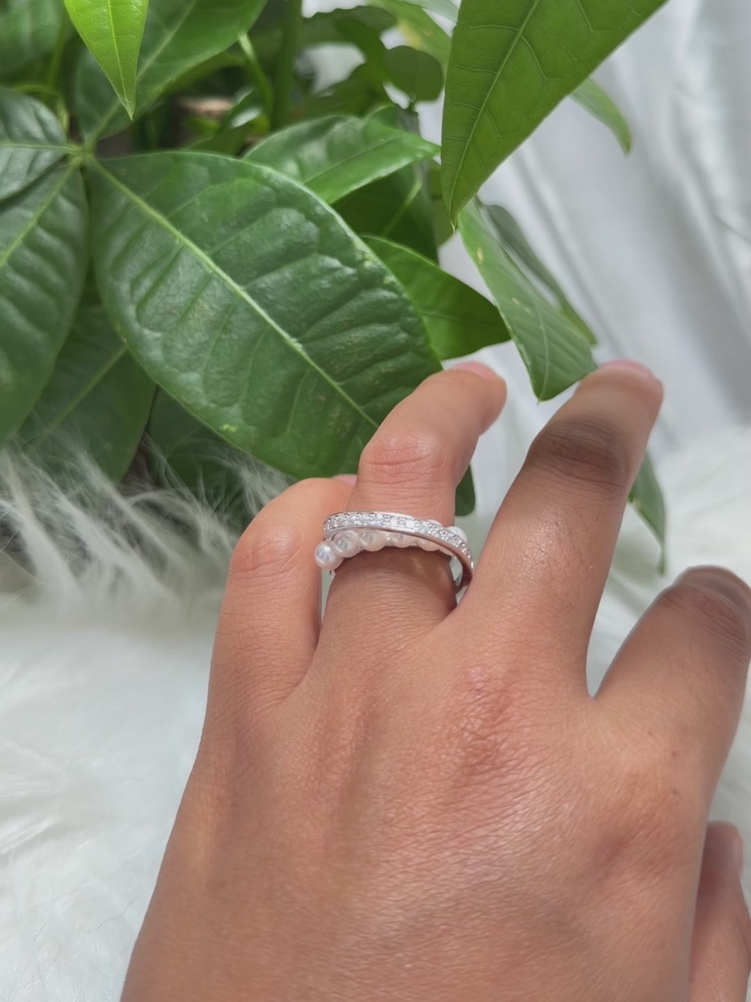 Modern pearl ring with a sparkling curved silver arc.