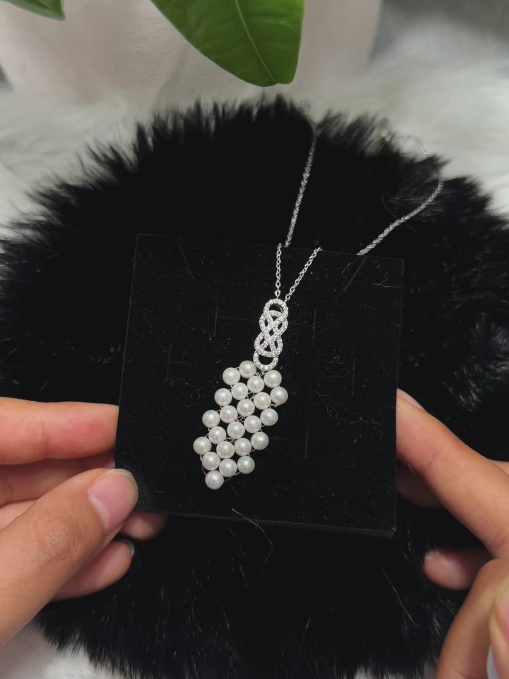 Delicate sterling silver chain with an intricate white pearl pendant.