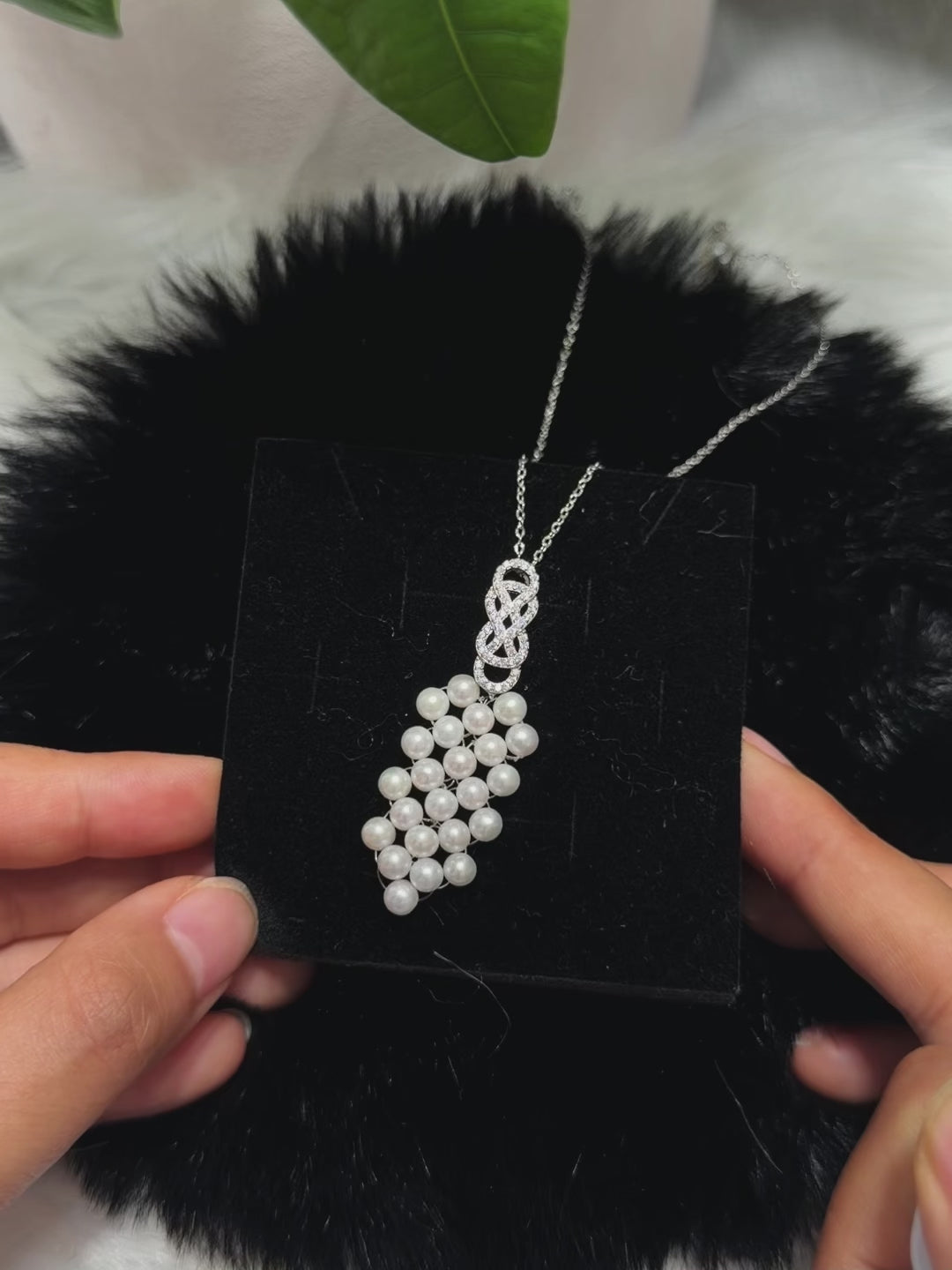 Delicate sterling silver chain with an intricate white pearl pendant.
