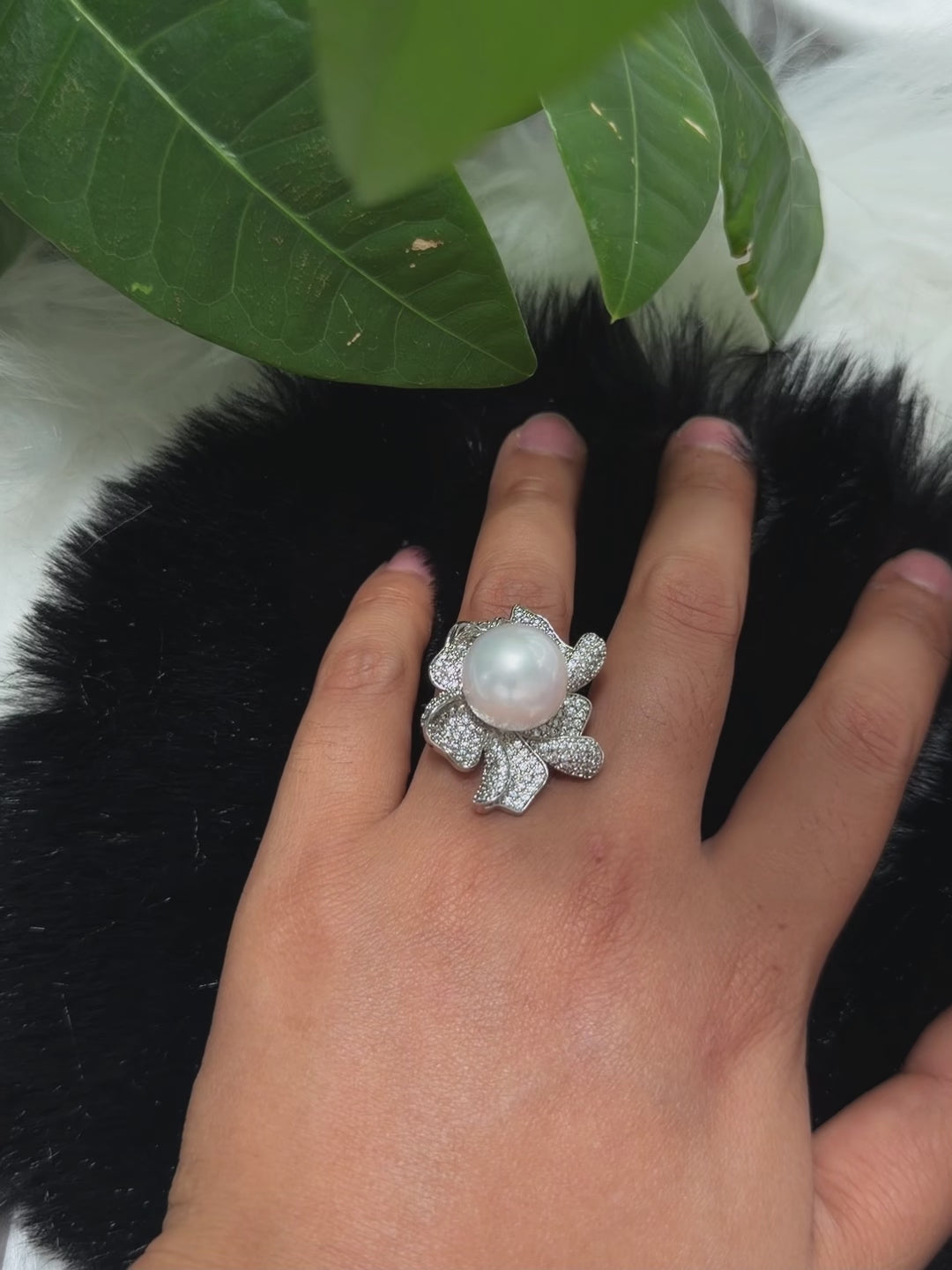 Sculptural floral pearl statement ring with sparkling accents.