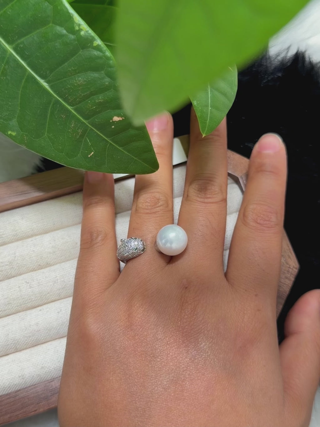 Panther pearl ring with bright green eye accents.